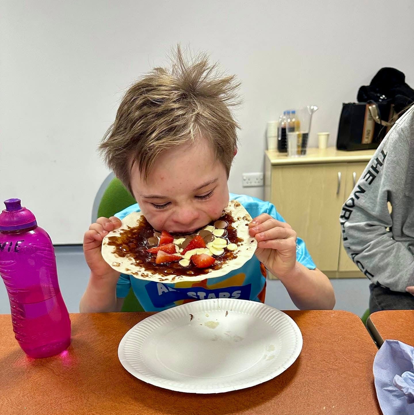 SENS Over 11 member enjoying his food creation